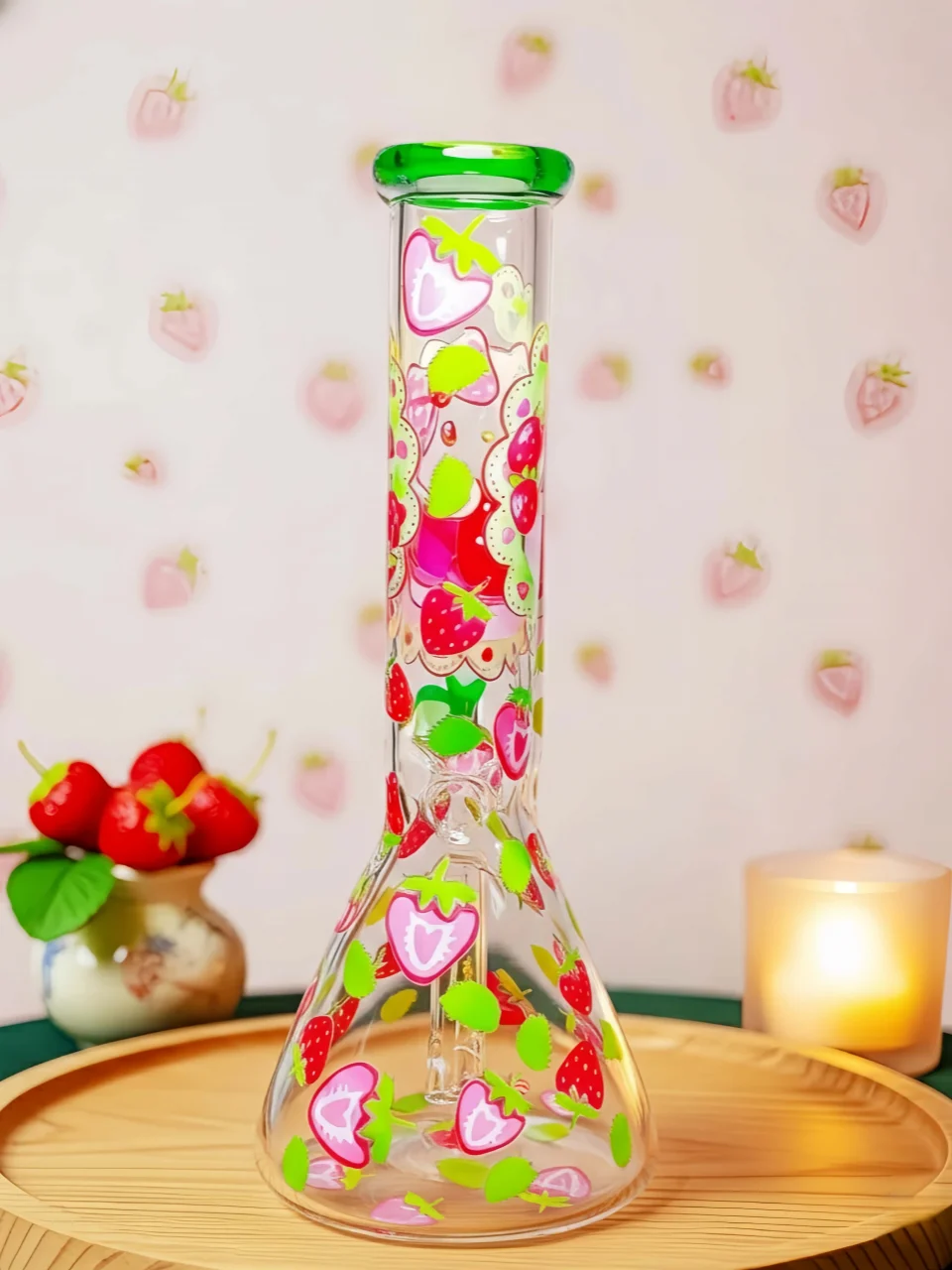 Hello Kitty strawberry beaker bong with green accents and clear glass. Fresh garden design, sweet summer vibes, smooth hits for Sanrio fans.